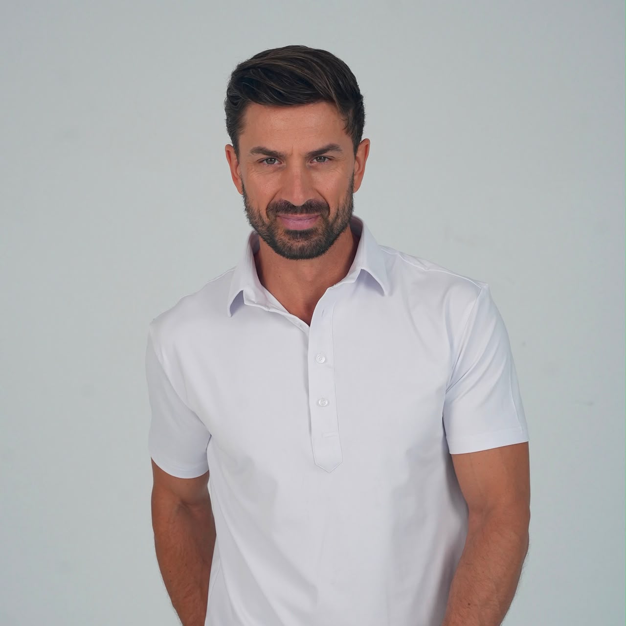 Man wearing a white performance polo by SOULVE
