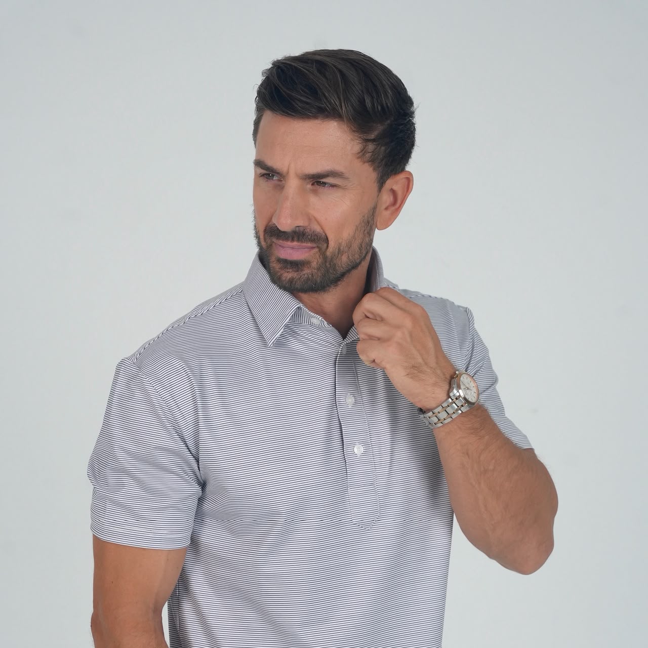 Man wearing a black micro stripe performance polo by SOULVE