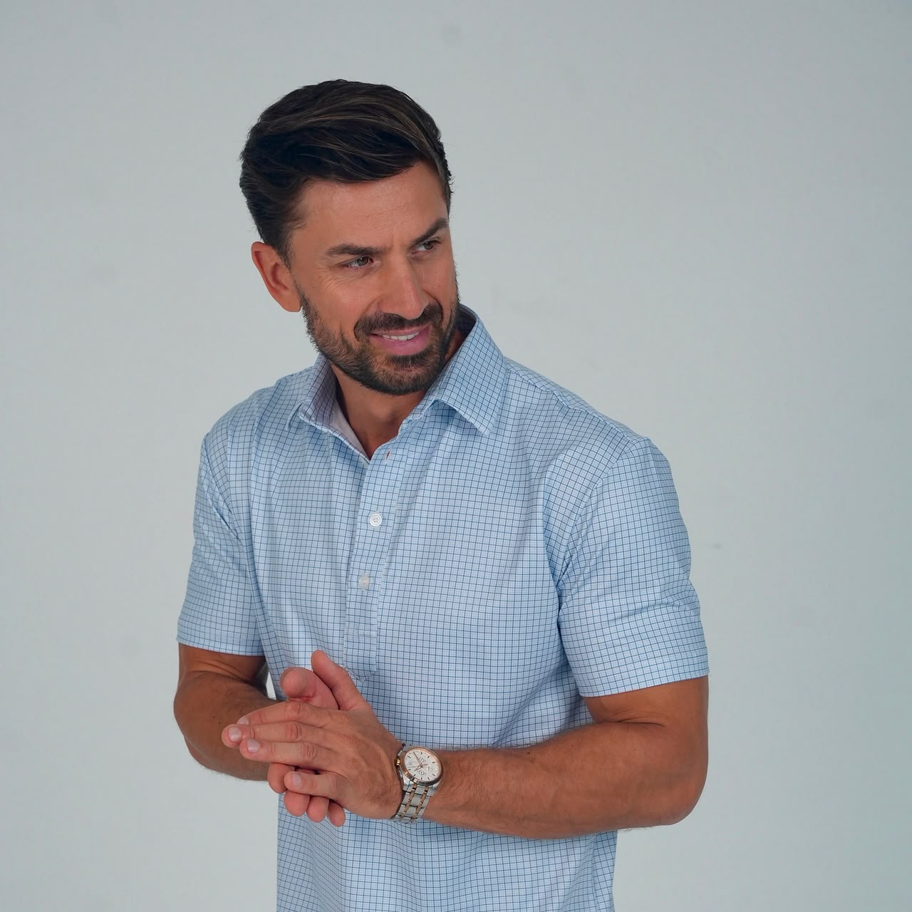 Man wearing a sky blue micro grid performance polo by SOULVE